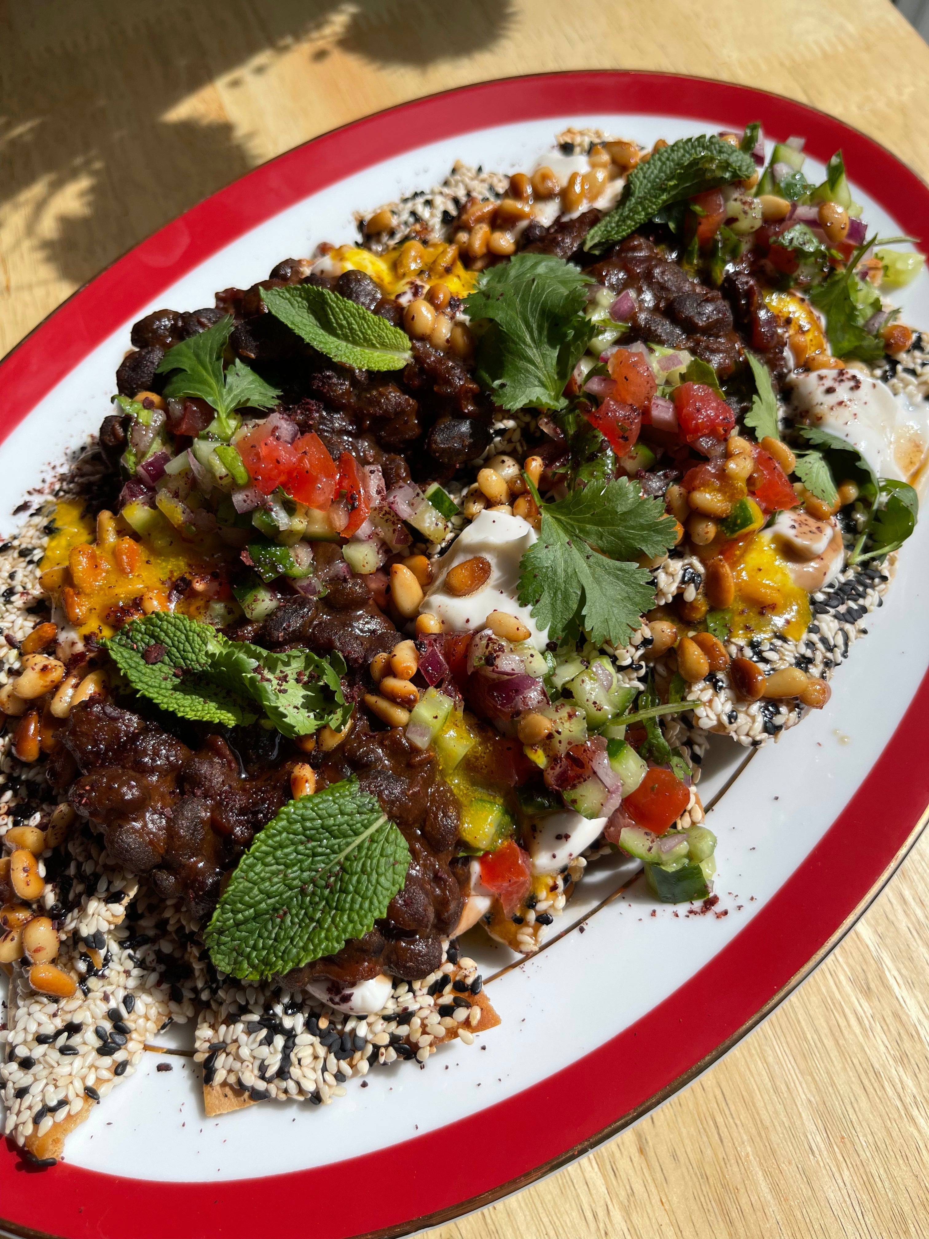 Black Bean Loaded Fatteh Nachos with Buttery Pine Nuts
